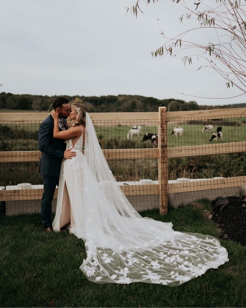 Bride and Groom next to a fence