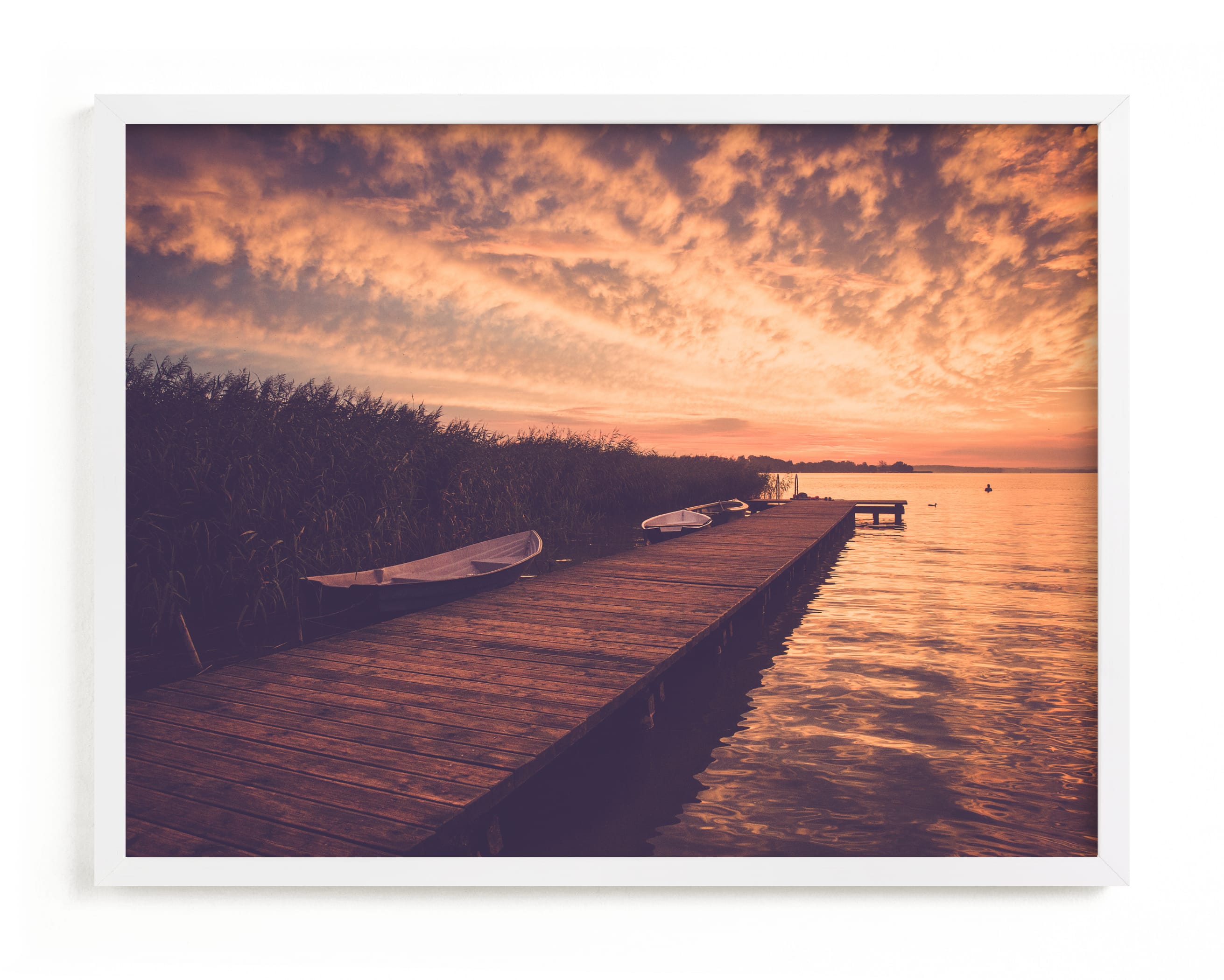 "Red sunset and boat" by Lying on the grass in beautiful frame options and a variety of sizes.